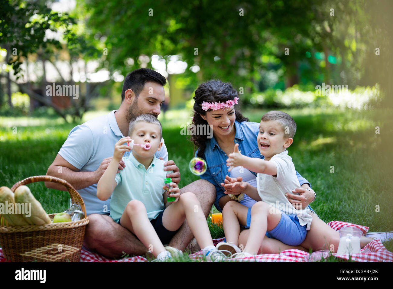 Family with children blow soap bubbles outdoors Stock Photo - Alamy