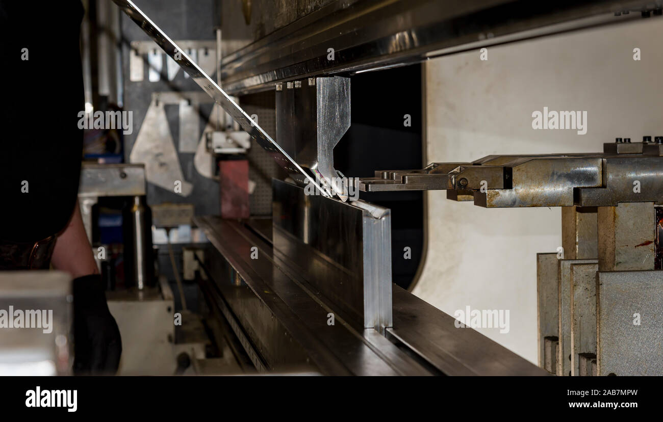 operator bending metal sheet by sheet bending machine bending of metal ...