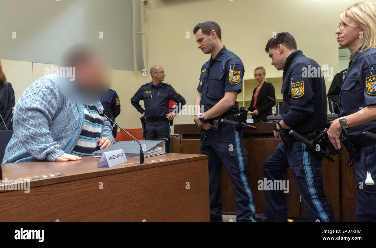 Munich, Germany. 26th Nov, 2019. The defendant (l) is standing in his place in court at the start of the trial. The auxiliary nurse is being tried for the murder of at least six patients. Credit: Peter Kneffel/dpa - ATTENTION: person(s) was/are pixelated for legal reasons/dpa/Alamy Live News Stock Photo