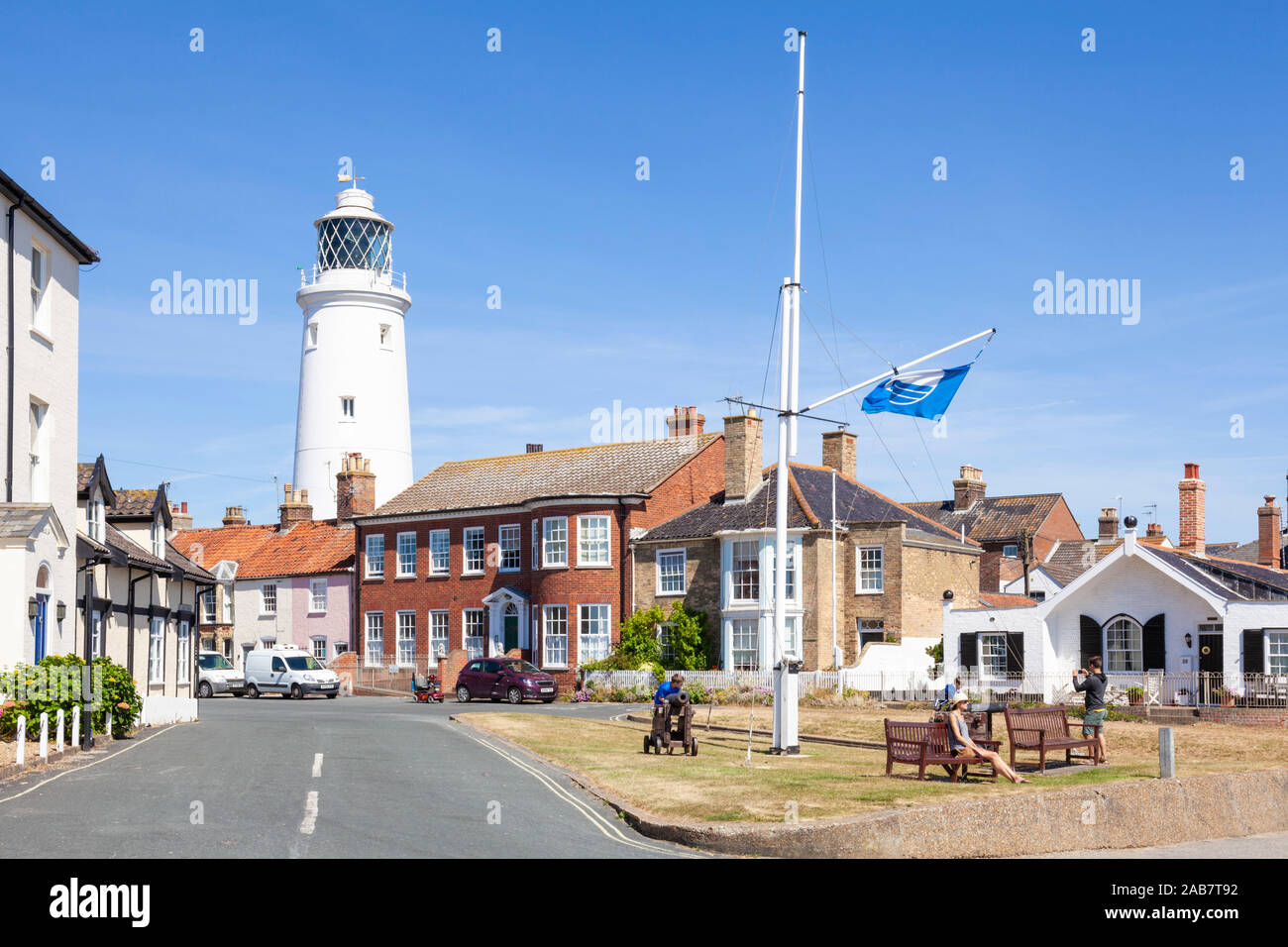 Southwold Lighthouse and houses, with people on a bench, St. James Green, East Cliff, Southwold, Suffolk, England, United Kingdom, Europe Stock Photo