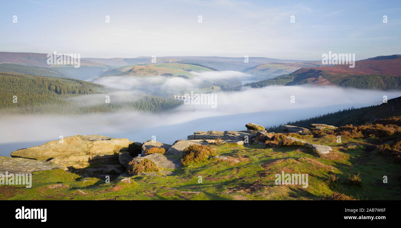 Early morning fog lingering above the Ladybower Reservoir in the valley below Bamford Edge, Peak District, Derbyshire, England, United Kingdom, Europe Stock Photo