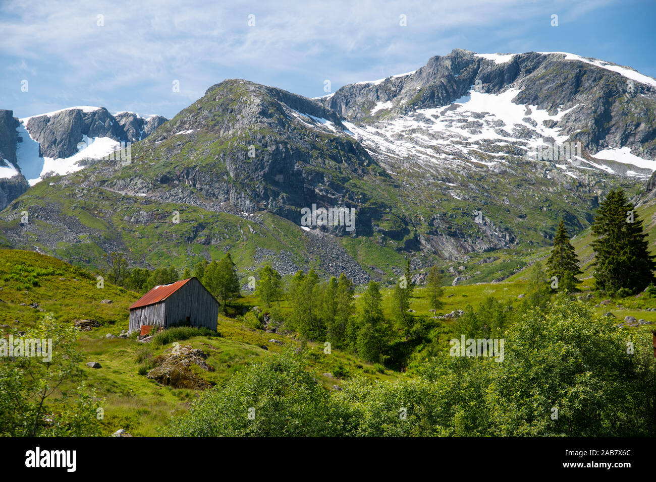 A wooden barn on a hillside below the Frudalsbreen Glacier, Vestlandet, Norway, Scandinavia, Europe Stock Photo