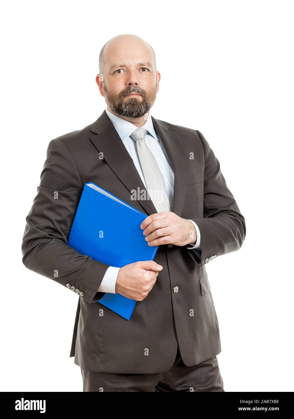 Ein tuechtiger Geschaeftsmann mit einem blauen Ordner im Anzug vor weissem Hintergrund Stock Photo