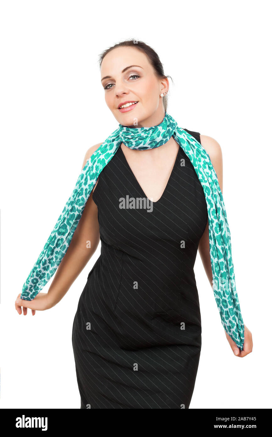 Eine tuechtige Geschaeftsfrau mit einem tuerkisen Schal vor weissem Hintergrund Stock Photo