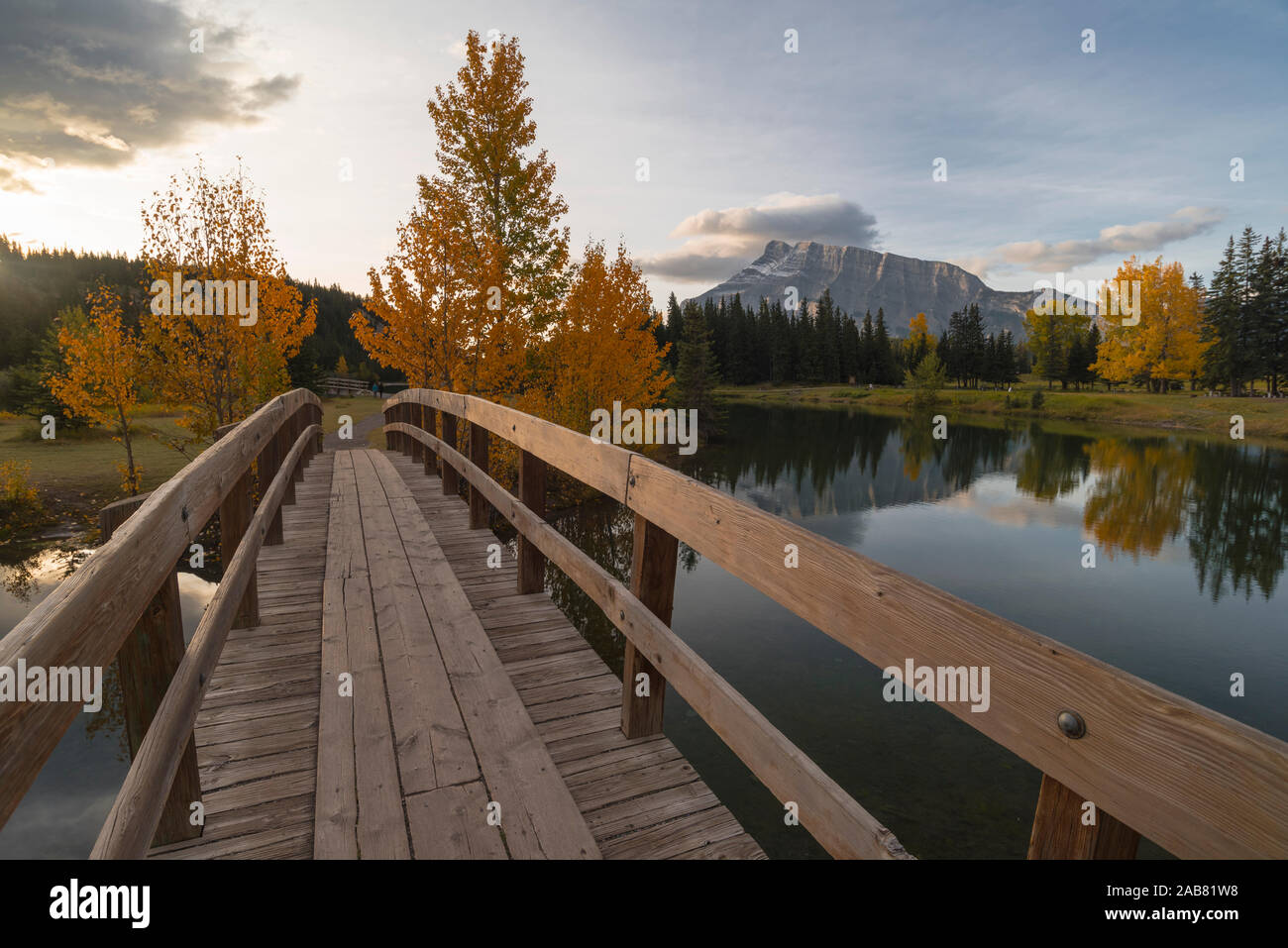 Bridge over Cascade Pond with Mount Rundle on horizon in autumn, Banff National Park, UNESCO, Alberta, Rocky Mountains, Canada, North America Stock Photo