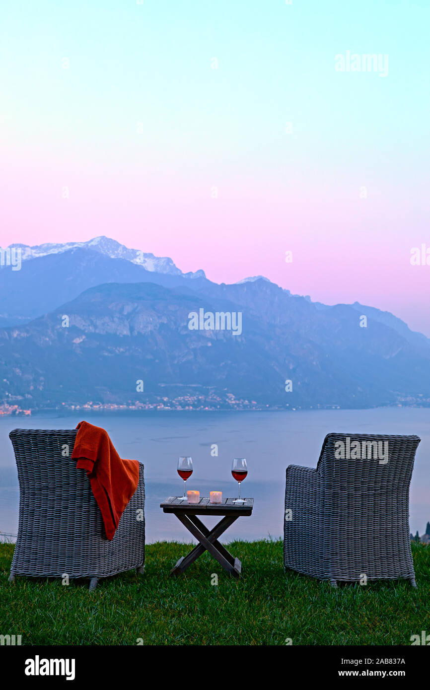 Armchairs and red wine with views of Lake Como at sunset, Lombardy, Italian Lakes, Italy, Europe Stock Photo