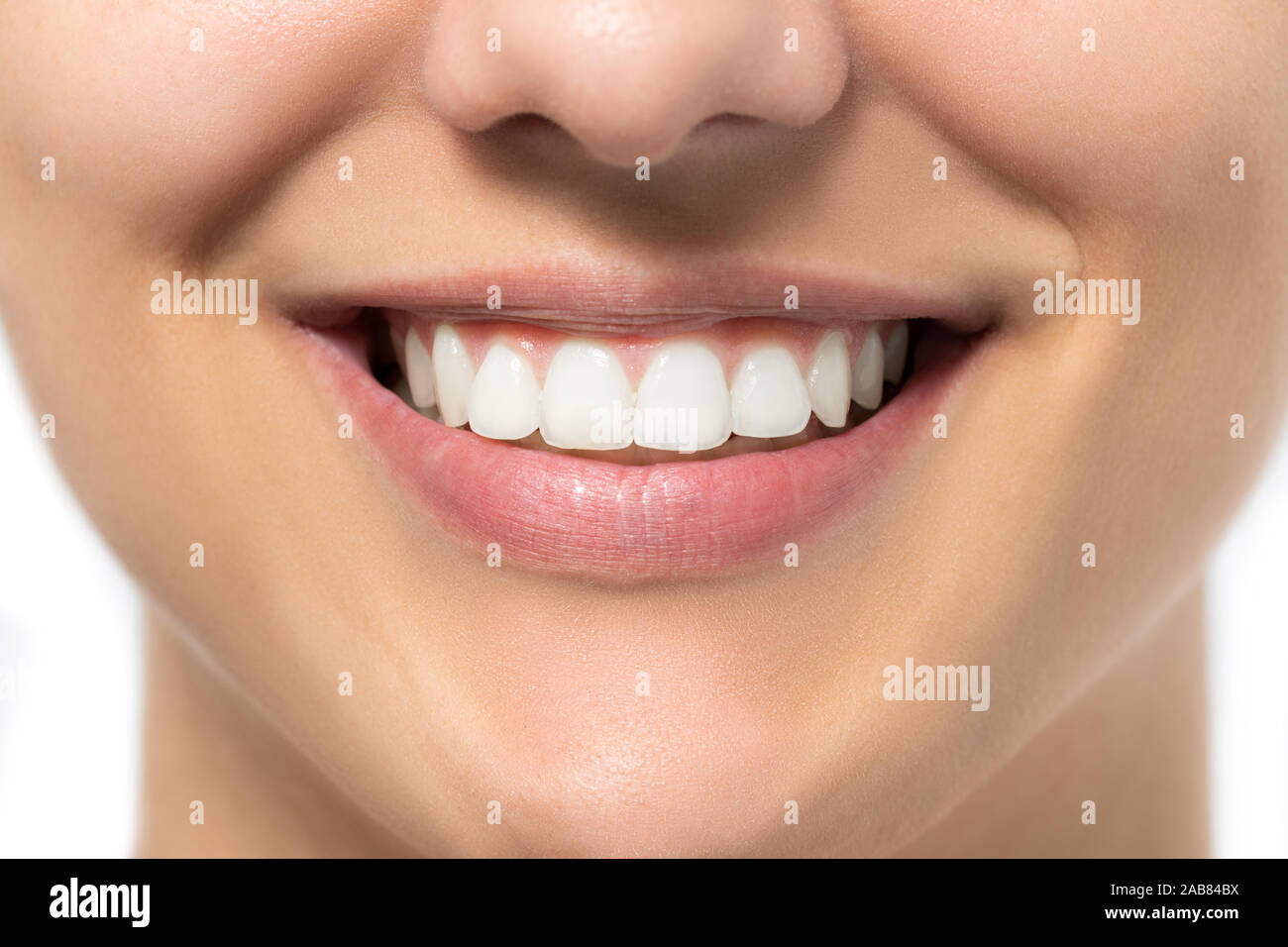Extreme close up of charming female smile. Young woman showing white healthy teeth. Stock Photo