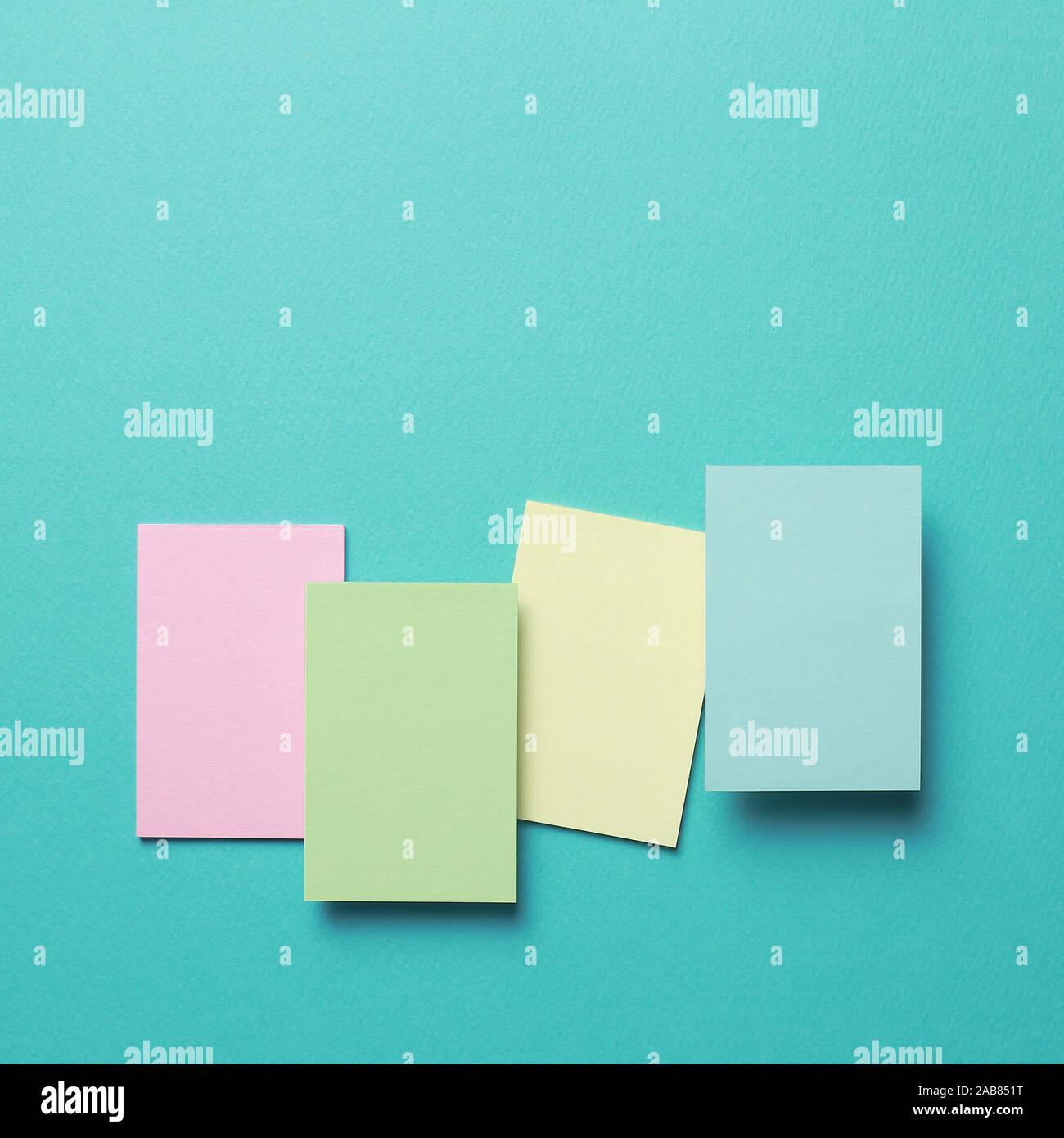 Colorful memo pad, sticky notes on mint background Stock Photo