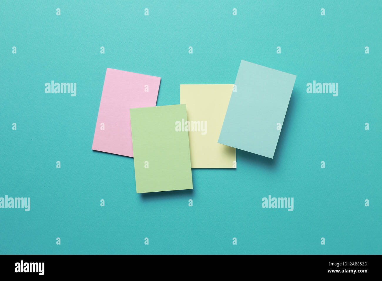 Colorful memo pad, sticky notes on mint background Stock Photo