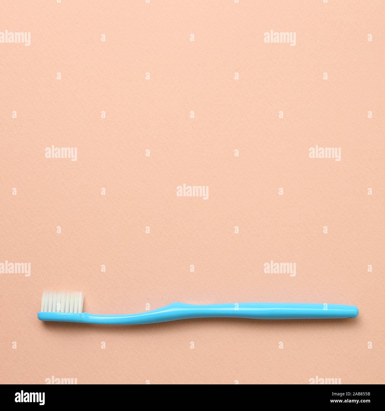 Blue toothbrush on pink background Stock Photo