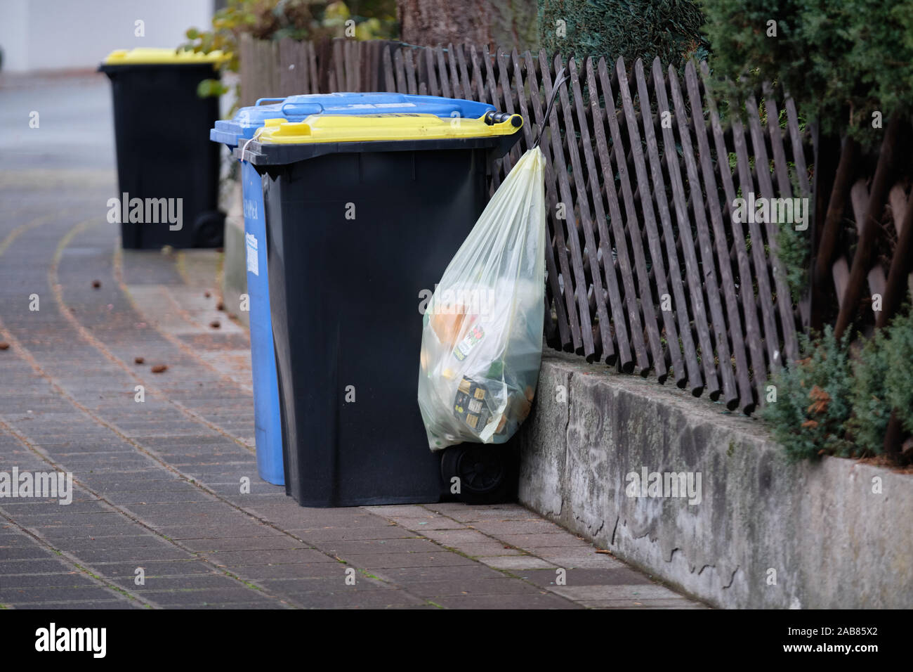 Nuremberg, Germany - November 25, 2019: A yellow bag called Gelber Sack is  hanging on a trellis-work fence with a Gelbe Tonne behind that wil replace  Stock Photo - Alamy