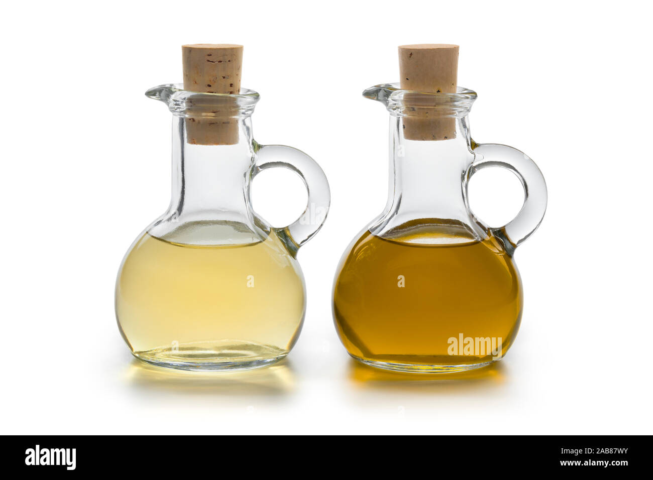 Pair of two glass bottles with oil and vinegar isolated on white