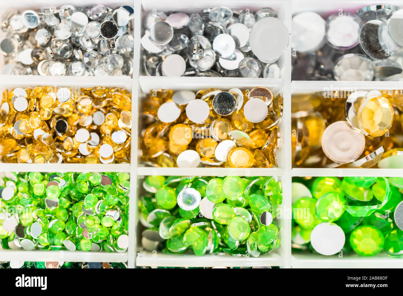 Comparing Craft Rhinestones Color and size variety of rhinestones in the craft box Stock Photo - Alamy