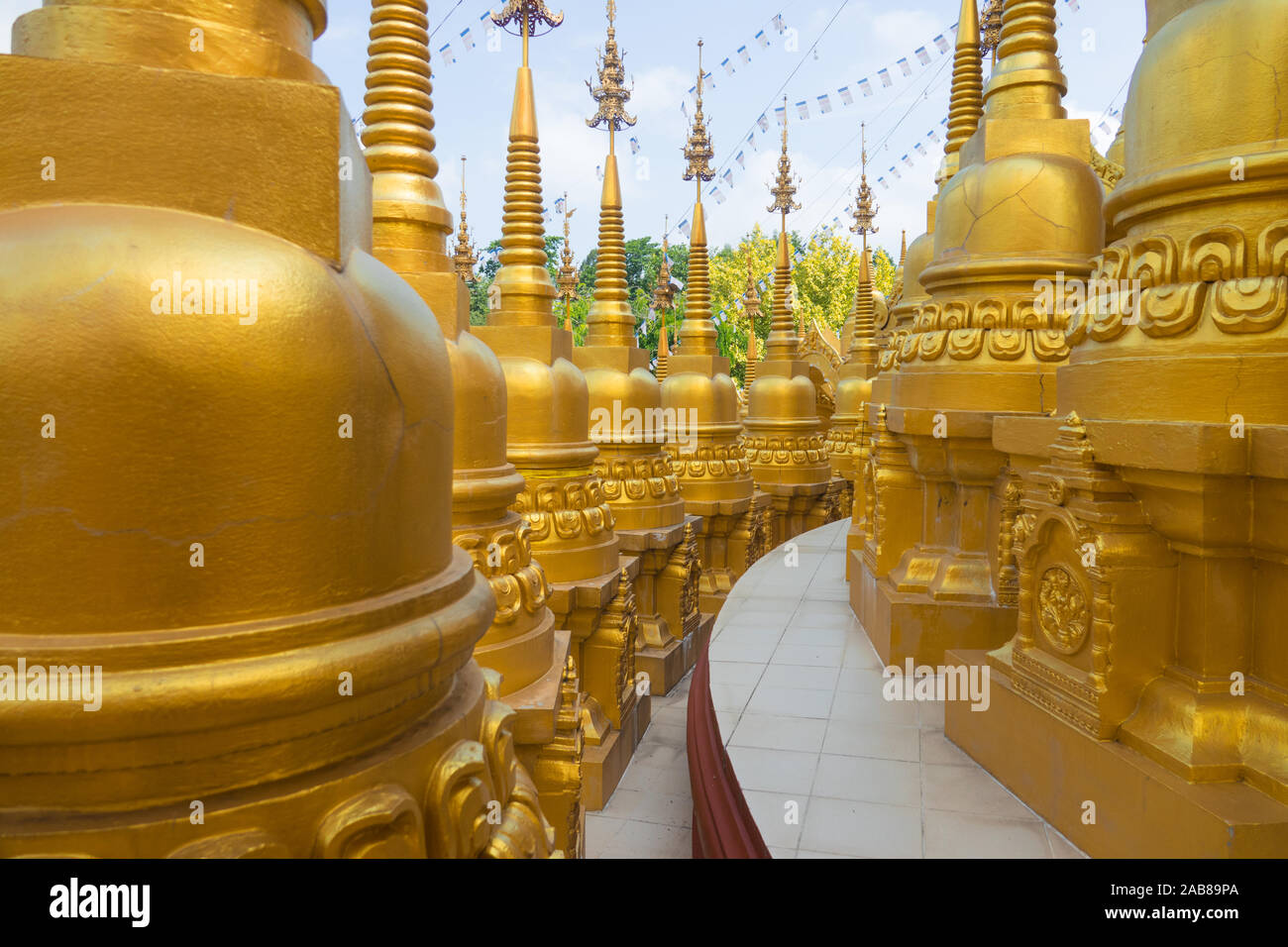 Many gold pagodas at Wat Pa Sawang Bun in Saraburi Province Thailand. There are 500 small pagodas decorated around big pagoda. Stock Photo