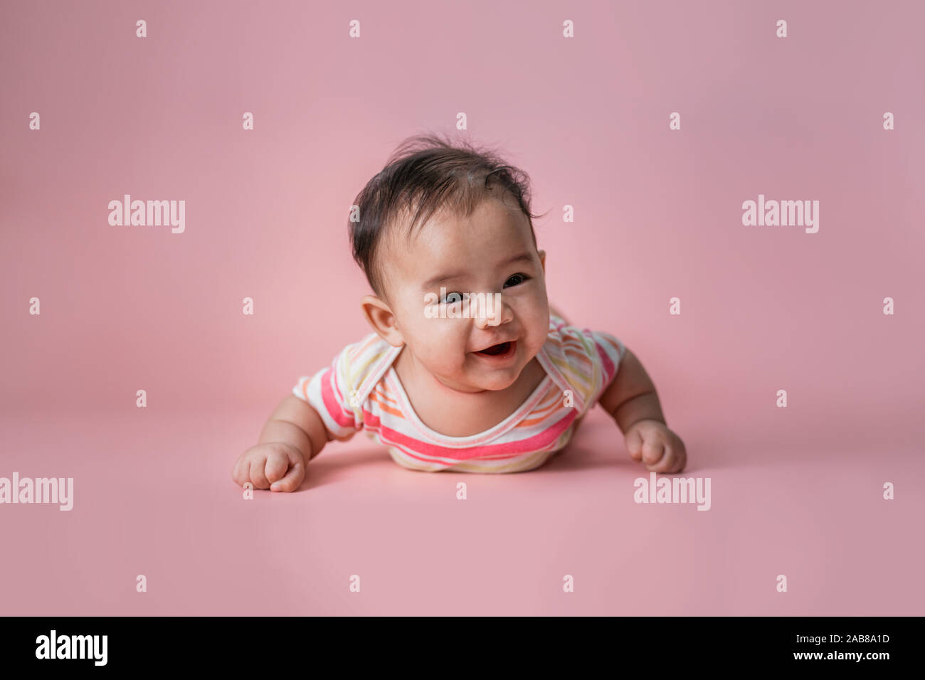 baby laying on her belly in studio Stock Photo Alamy