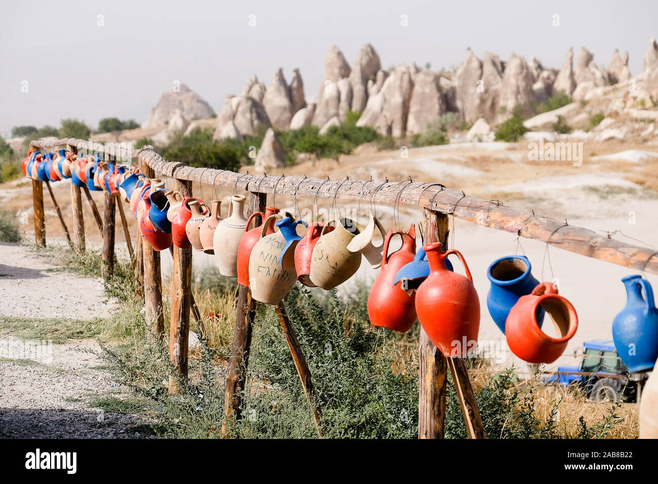Pots and jugs hanging on a fence in Cappadocia Stock Photo