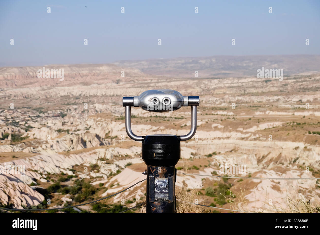 Coin operated binoculars looking over rocky open landscape Stock Photo