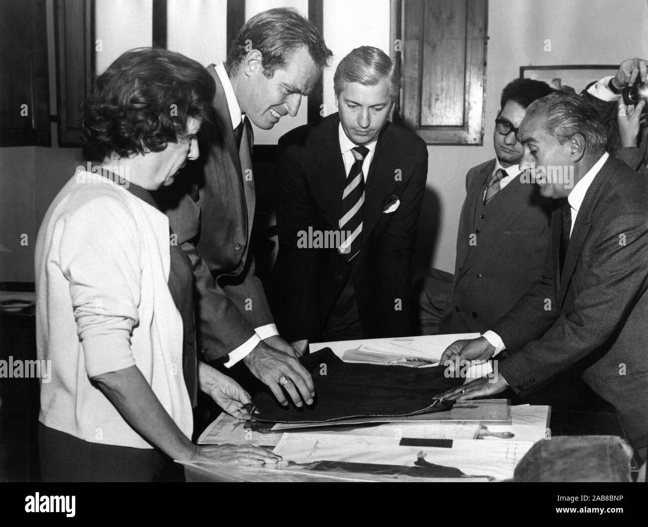 CHARLTON HESTON in Florence Italy inspects material for first costume fittings for EL CID 1961 director ANTHONY MANN music Miklos Rozsa Italy / USA co-production Samuel Bronston Productions / Dear Film Produzione Stock Photo