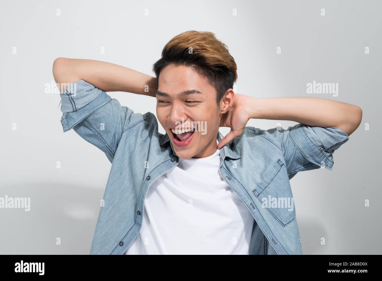 A portrait of happy excited young Asian man isolated on white ...