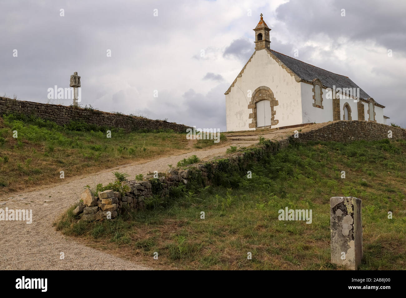 Megalithic grave mound Tumulus of St Michel with chapel of Saint Michel near Carnac in Brittany, France Stock Photo