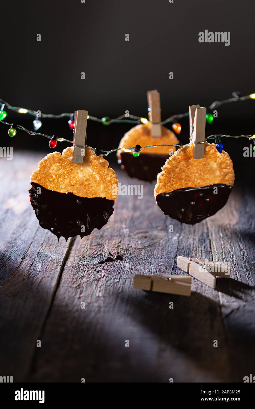Healthy cakes hanging on Christmas lights.Vintage style.Delicious food and dessert Stock Photo