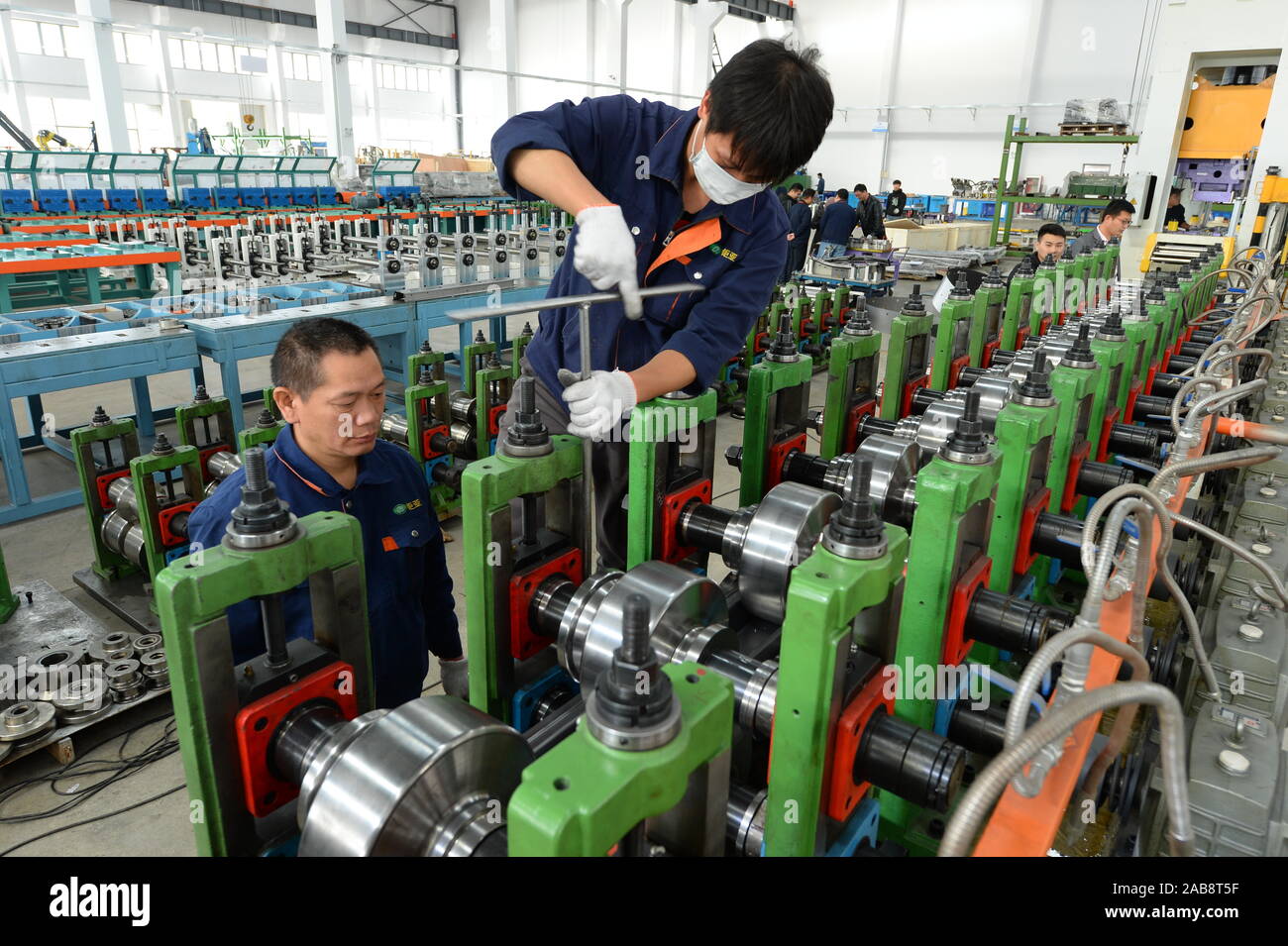 Chinese and Malaysian technicians check an auto parts assembly line to be exported to Malaysia