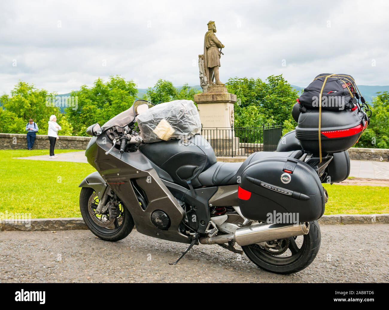 Touring motorcylce parked on castle esplanade & Rbert the Bruce statue, Stirling Castle, Scotland, UK Stock Photo