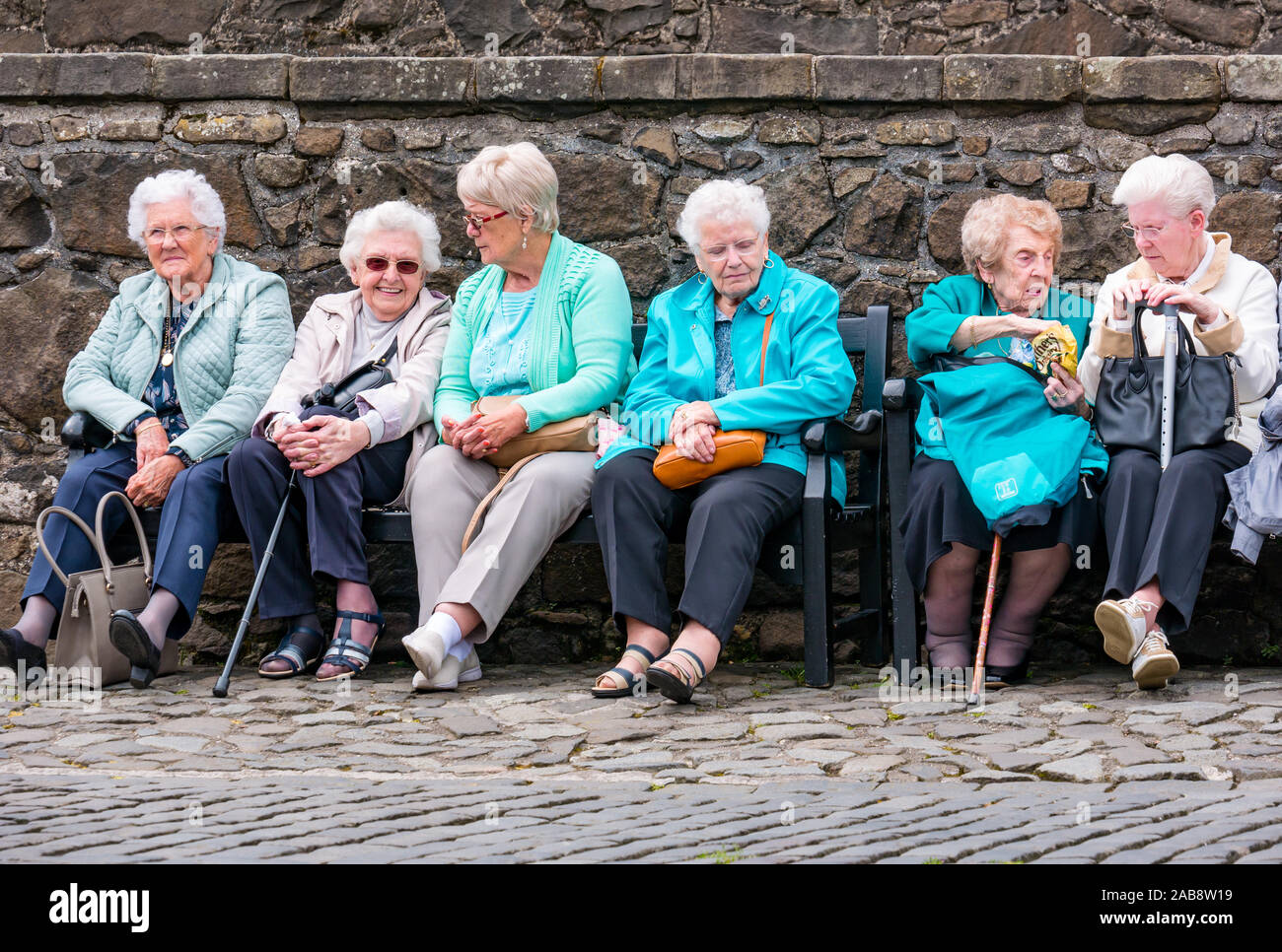 Group of elderly women sitting on bench on day trip outing, Stirling Castle, Scotland, UK Stock Photo