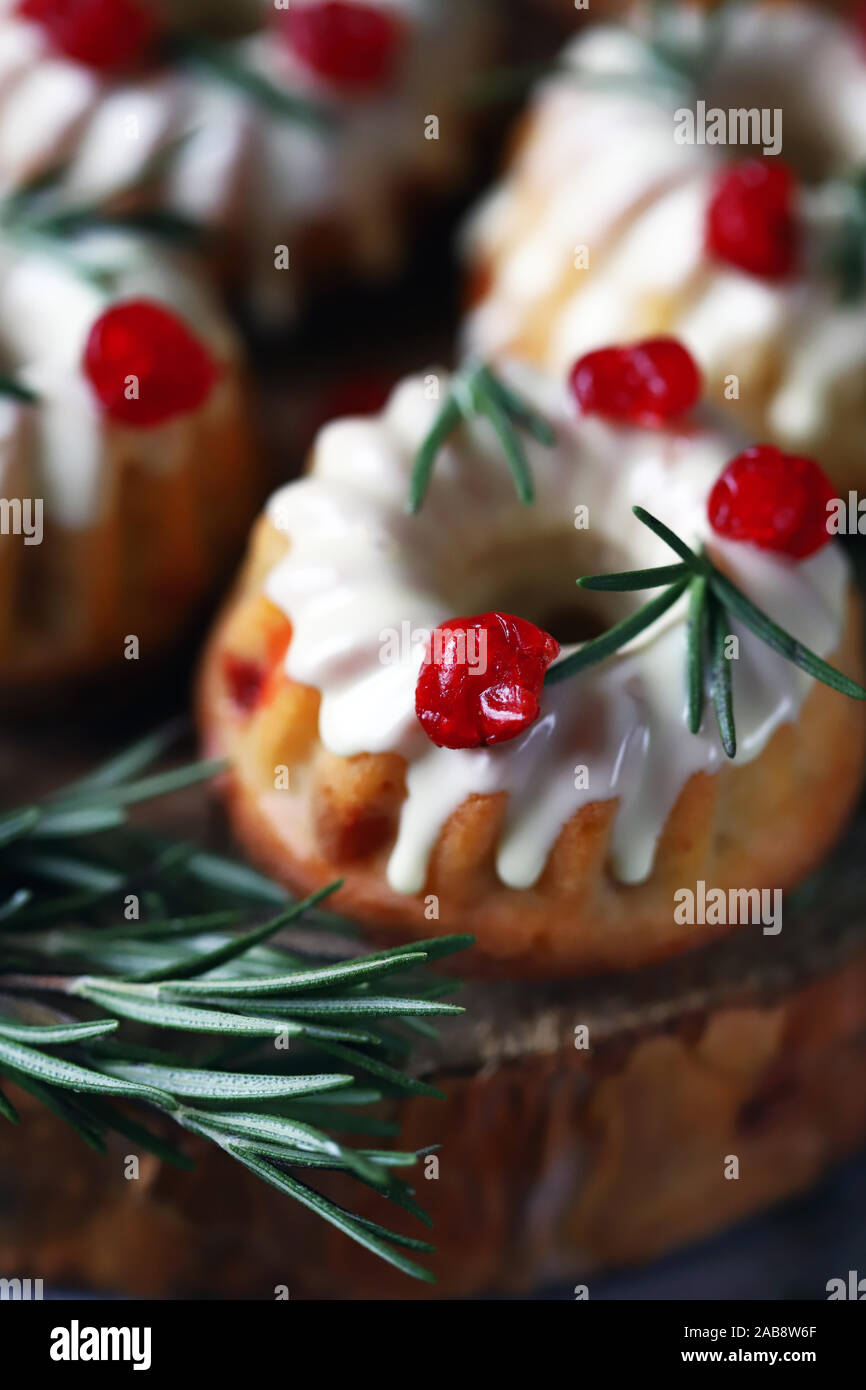 Christmas Cakes With White Icing Red Berries And Rosemary