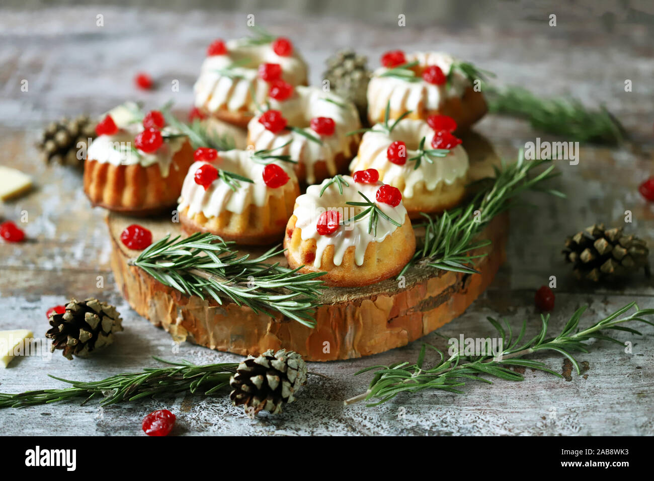 Christmas Cakes With White Icing Red Berries And Rosemary