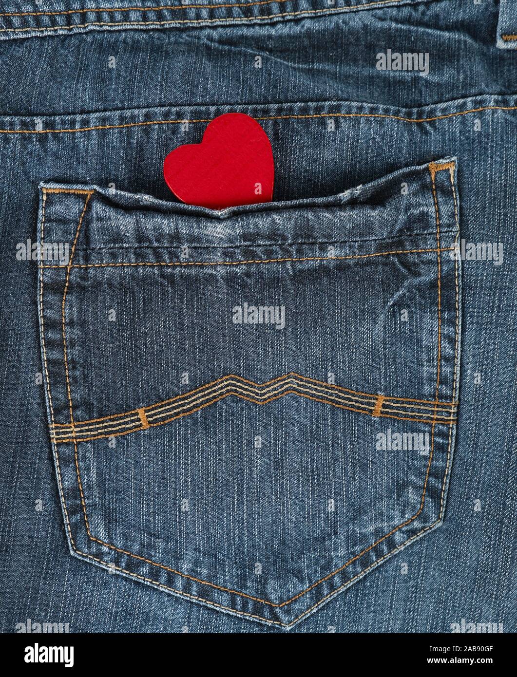 small red heart in the back pocket of blue jeans, full frame Stock Photo -  Alamy