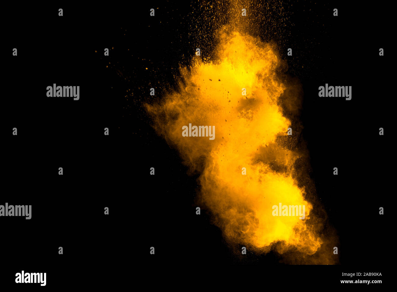 Abstract orange powder explosion on black background. Freeze motion of orange powder splash. Stock Photo