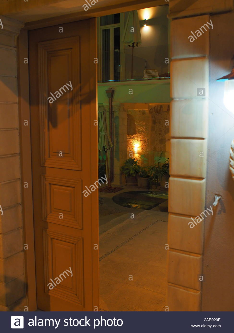 Open Door Of A Building At Night In The Old City Of Rethymno