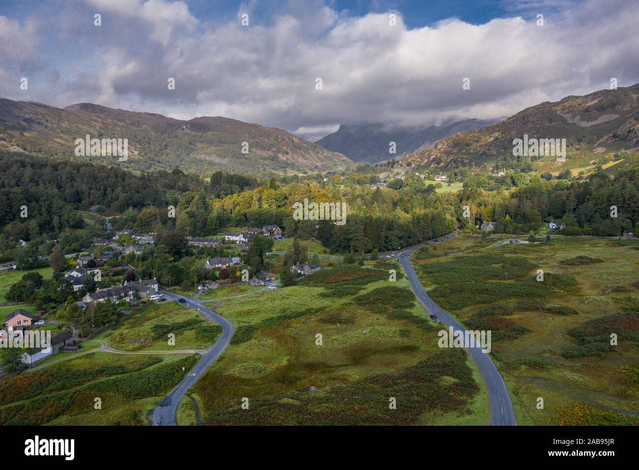 Drone shoot over Elterwater village and Langdale Pikes in Lake District National Park, UK Stock Photo