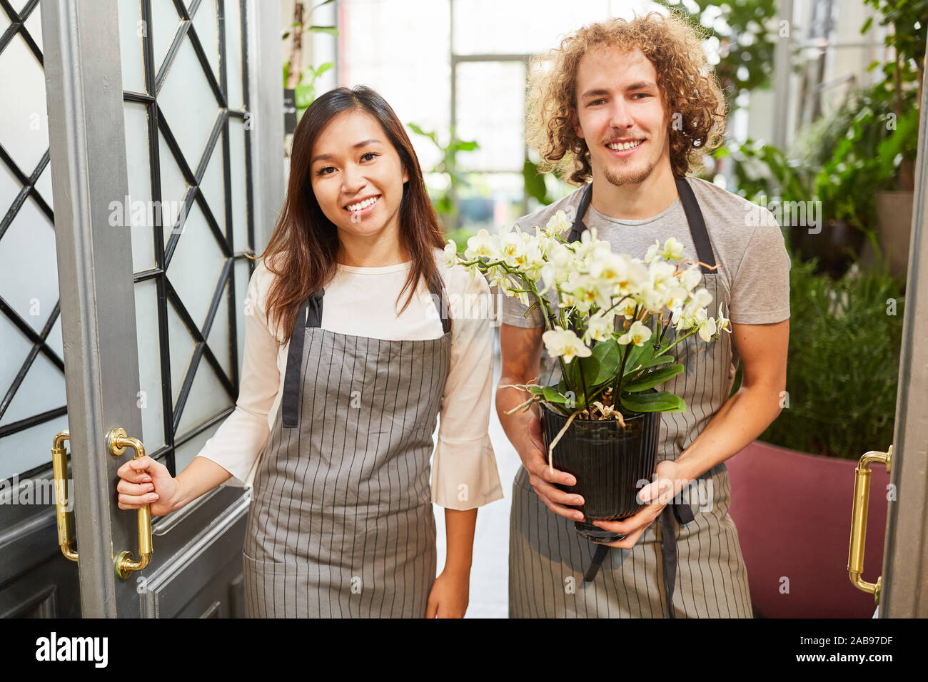 Smiling florist team delivering flower as customer service Stock Photo