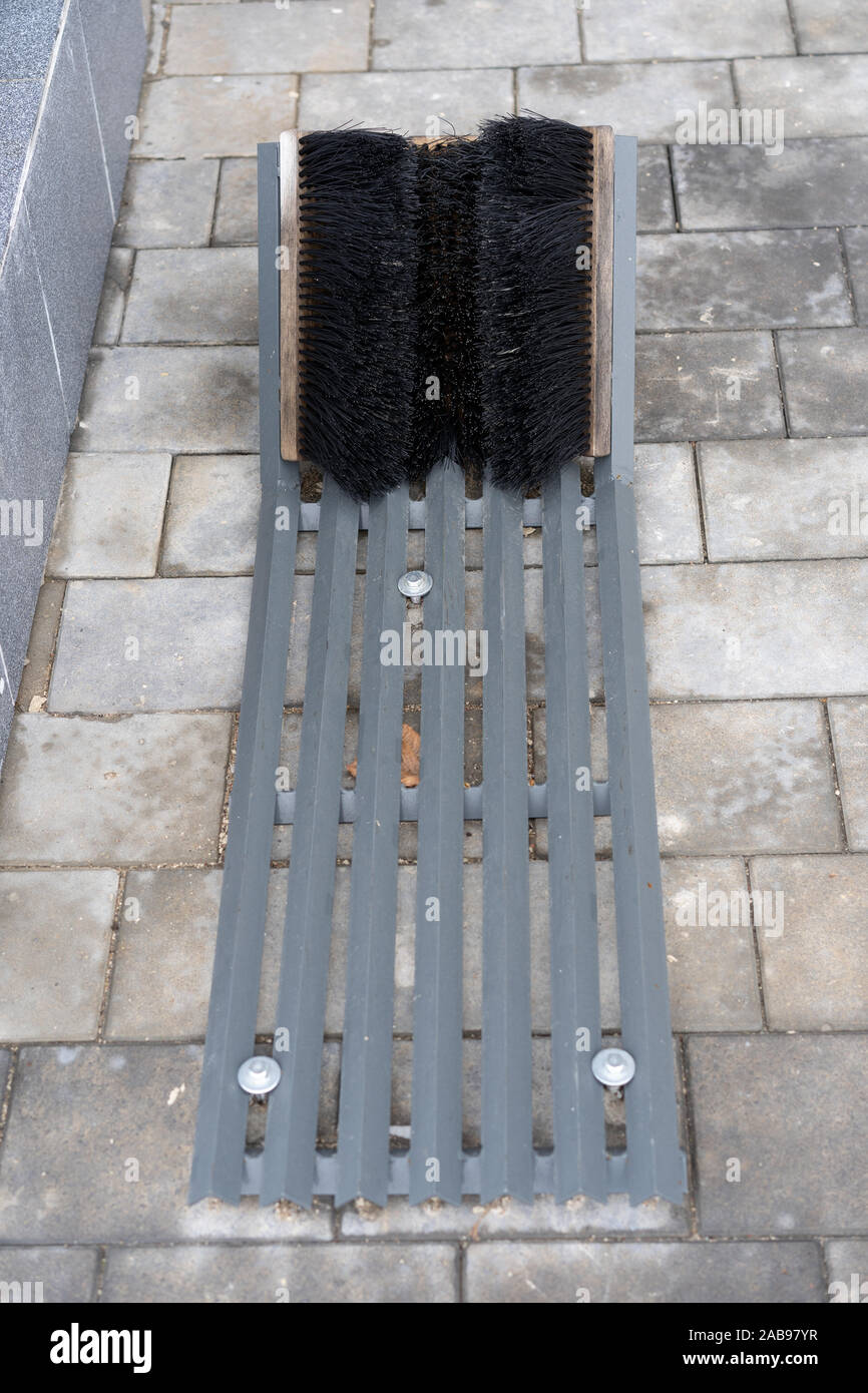 shoe brush near the entrance of a residential building Stock Photo Alamy