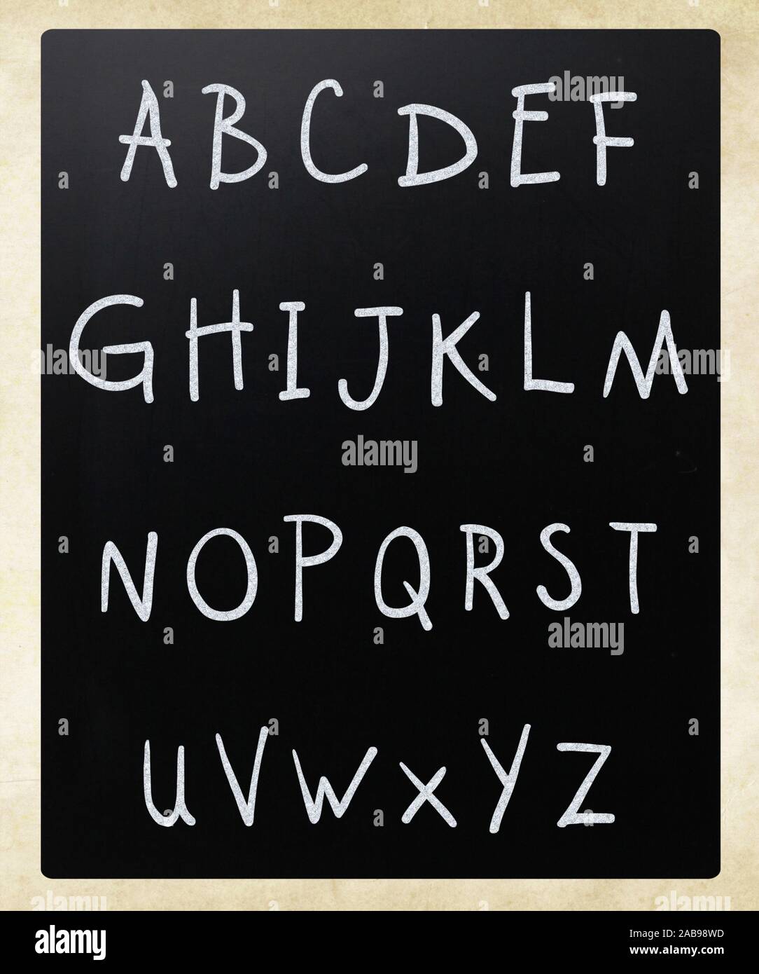 Complete english alphabet handwritten with white chalk on a blackboard