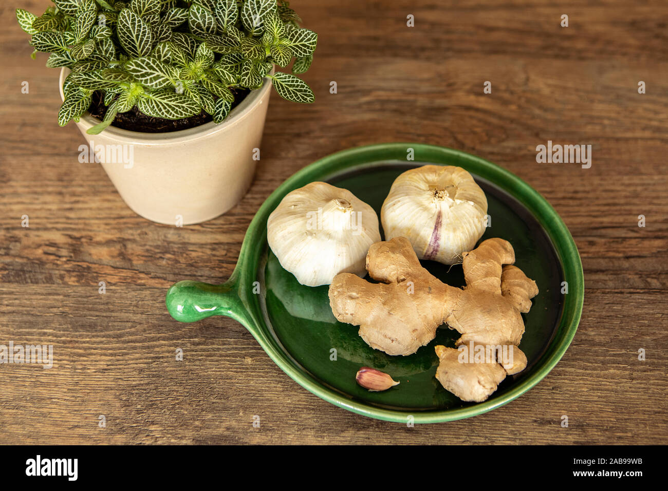 Fresh and healthy garlic and ginger on the kitchen counter, concept for health improvement. Treatment of flu by a natural method.  Natural method to Stock Photo