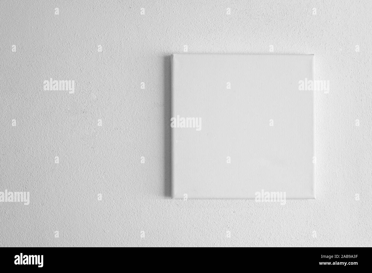 single white blank rectangular canvas frame on cement wall background