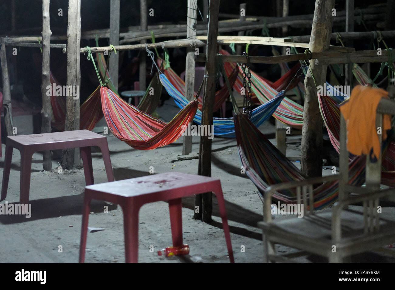 A place to sleep in a barn with hammocks tied to the crossbar between