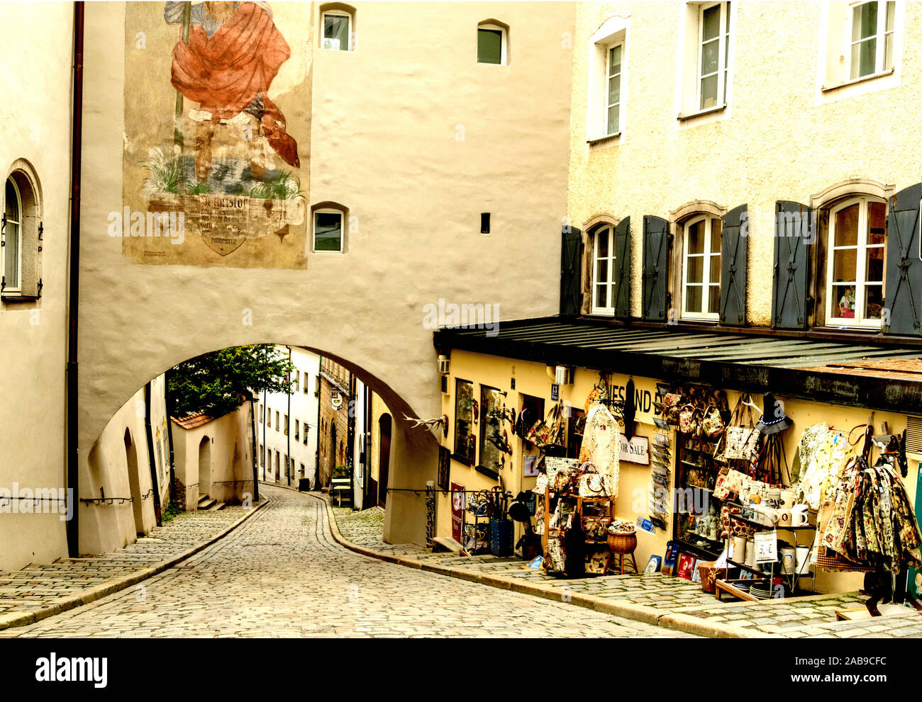 A tourists boutique beside an archway leading to the river side in Passau, Germany Stock Photo