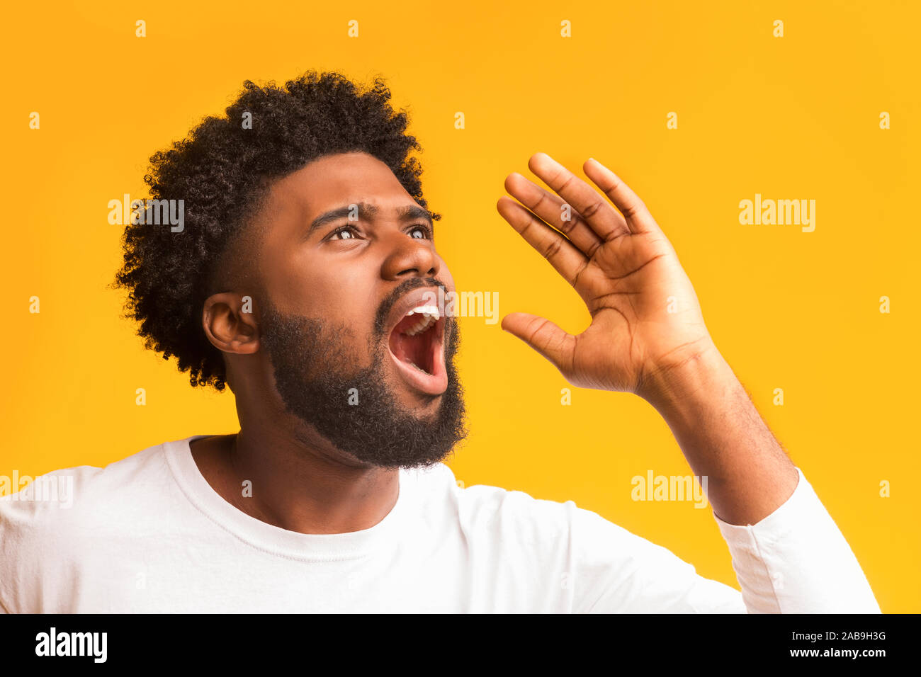 Portrait Of Shocked Black Guy Screaming Over Orange Background
