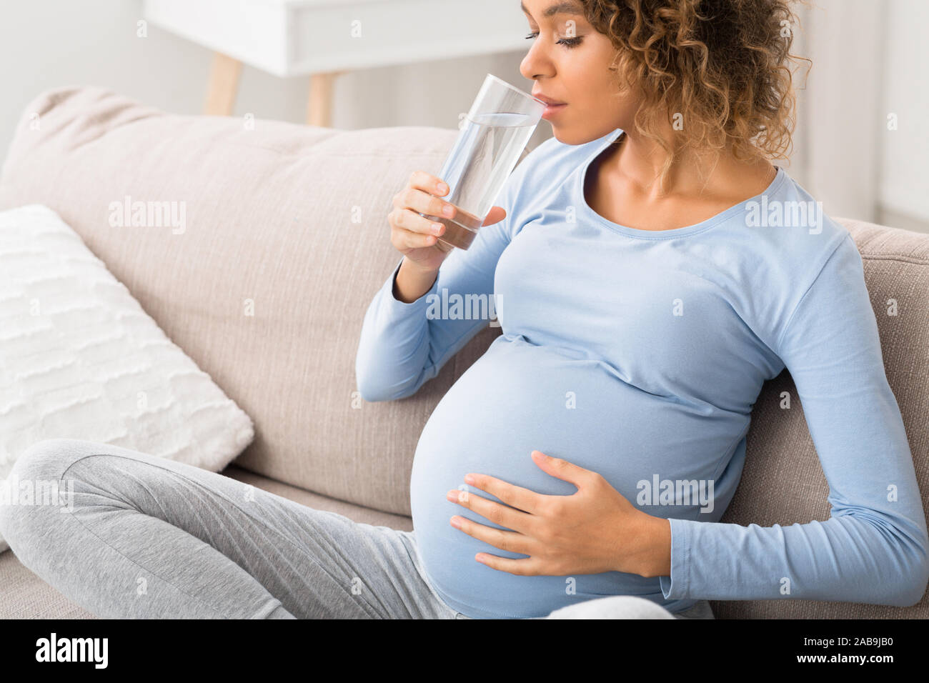 Pregnancy and hydration. Expectant woman drinking water Stock Photo Alamy