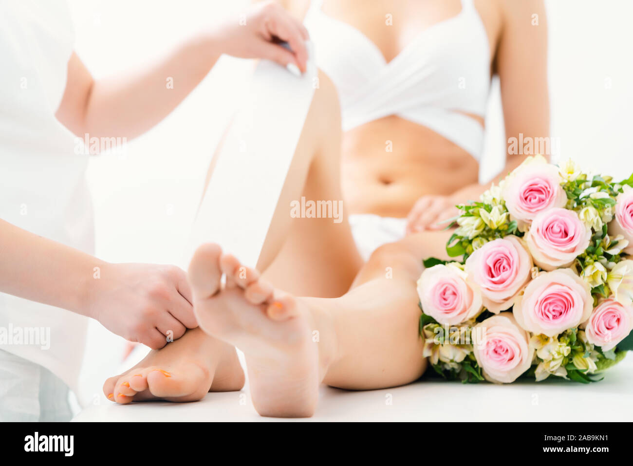 Hair Removal Using Wax Strips At The Legs In Beauty Parlor Stock