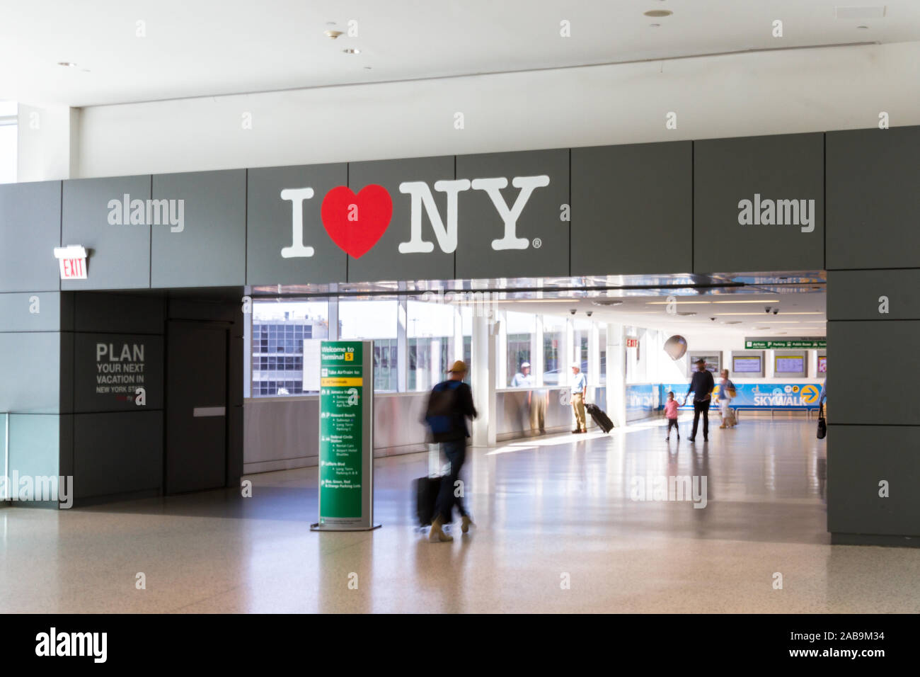 JFK Airport, Queens NY  - September 03 2019: Popular I Love NY slogan above the walkway with blurred travelers walking by. JFK Airport, NY September 0 Stock Photo