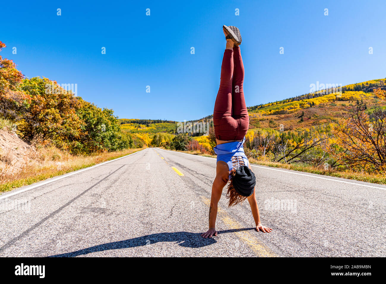 Beautiful woman doing handstands in Colorado's outdoors Stock Photo