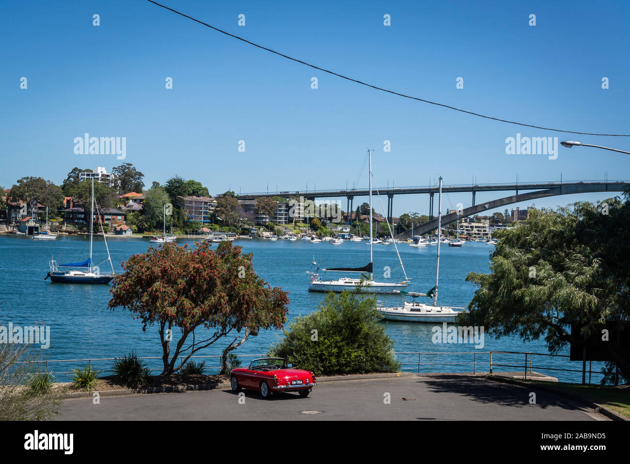 MG Convertible car at Ferry Street Point with a view of Gladsville Bridge, Hunters Hill, a suburb on the Lower North Shore, Sydney, Australia Stock Photo