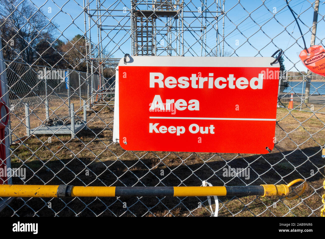 Restricted Area Keep Out red and white sign on chain link fence at construction site Stock Photo
