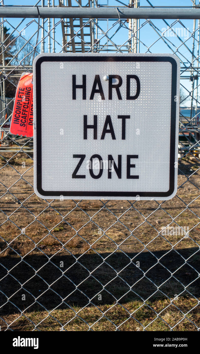 Hard Hat Zone sign on chain link fence at construction site Stock Photo