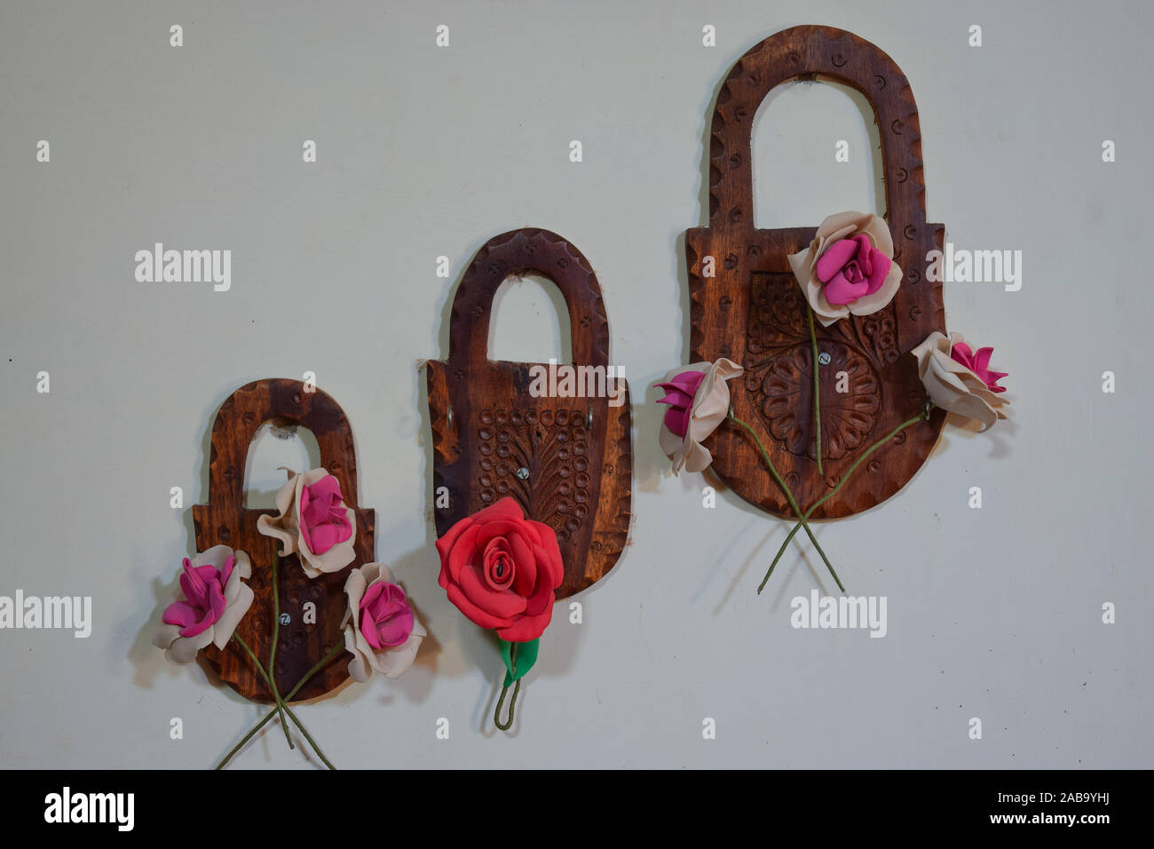 Decorated wall of a home with beautiful artificial flowers and multi colored necklace, selective focus point,from Pakistan Asia Stock Photo